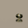 Natural sapphire gemstone, 0.39 carat, oval cut, bluish green color, unheated, loose gemstone, dimensions 4.84 × 3.96 × 2.60 mm, origin Madagascar, AIG certified.