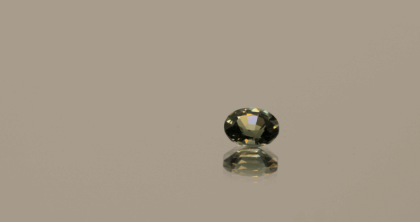 Natural sapphire gemstone, 0.39 carat, oval cut, bluish green color, unheated, loose gemstone, dimensions 4.84 × 3.96 × 2.60 mm, origin Madagascar, AIG certified.