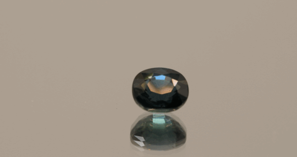 Blue sapphire gemstone 1.28 carat oval cut, heat treated, Madagascar origin, dimensions 6.27 × 5.54 × 3.89 mm, GFCO certified.