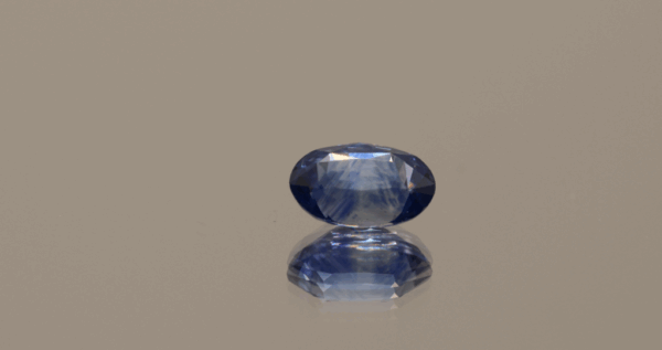 Blue sapphire gemstone, oval shaped, 1.18 carat, 7.40 × 4.86 × 3.83 mm, heat-treated, unknown origin, IGI certified.