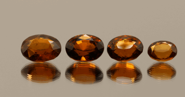 Set of 4 natural hessonite garnets, 12.31 carats total, oval cut, orange color, untreated