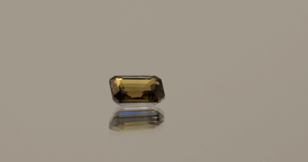 Brownish yellow octagon-shaped zoisite, 0.89 carat, 6.48 × 4.52 × 2.85 mm, treatment unknown, Tanzania origin, AIG certified (GEM20231025102540).
