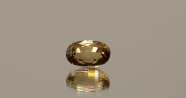 Brownish yellow oval-shaped zircon, 2.89 carat, 9.1 × 5.99 × 4.59 mm, untreated, unknown origin, IGI certified (M2H91448).