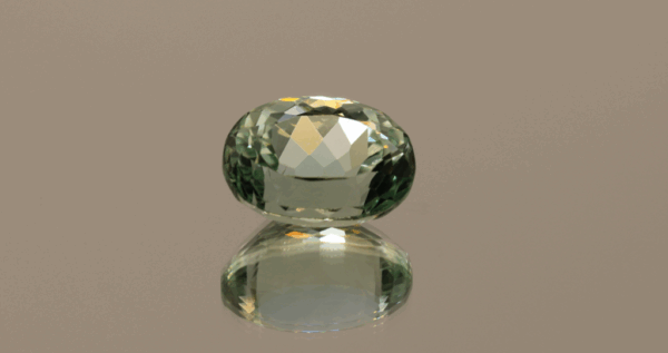 Light green oval-shaped spodumene, 8.18 carat, 13.5 × 9.9 × 8.1 mm, no treatment, unknown origin.