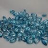 Lot of pear-shaped faceted natural neon blue zircon gemstones from Cambodia, displaying sparkling clarity and color