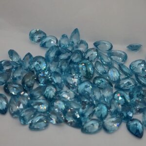 Lot of pear-shaped faceted natural neon blue zircon gemstones from Cambodia, displaying sparkling clarity and color